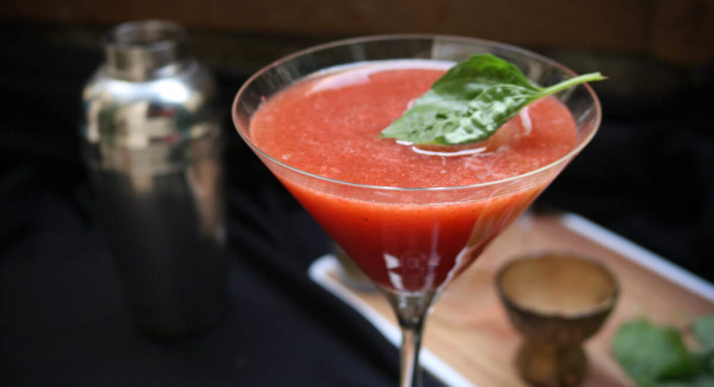 Last step on how to make strawberry cocktail basil bourbon crash